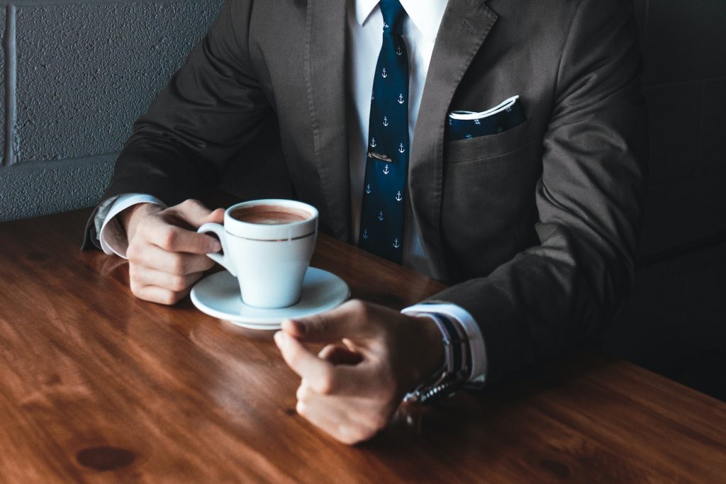Man holding coffee during negotiating